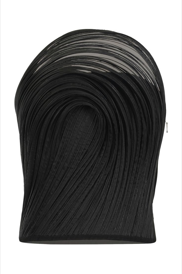 this is a closeup image of a black, pleated fabric arranged in a draped, flowing design. the pleats create a strong sense of texture and depth, giving the piece a threedimensional quality. the arrangement of the fabric forms abstract, curving lines. it appears to be a detailed section of a garment or artistic textile piece.