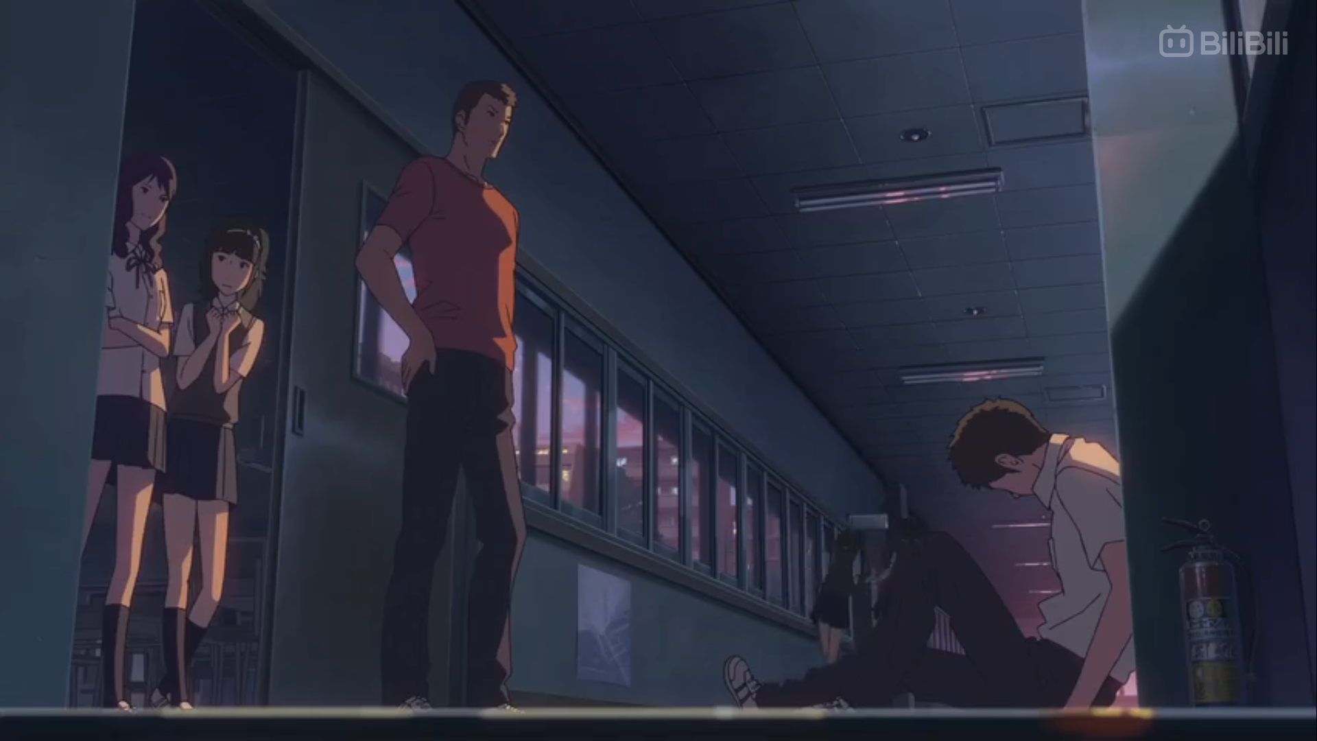 in an dimly lit school hallway with windows revealing a sunset, a male student sits slumped against a wall on the right side of the image. in the foreground on the left side of the image, a tall man in a red shirt stands facing the student. two girls in school uniforms stand behind him to his left, with one girl peering around him at the seated student. other students in the background look on at the scene. the overall mood of the image is dramatic and tense.
