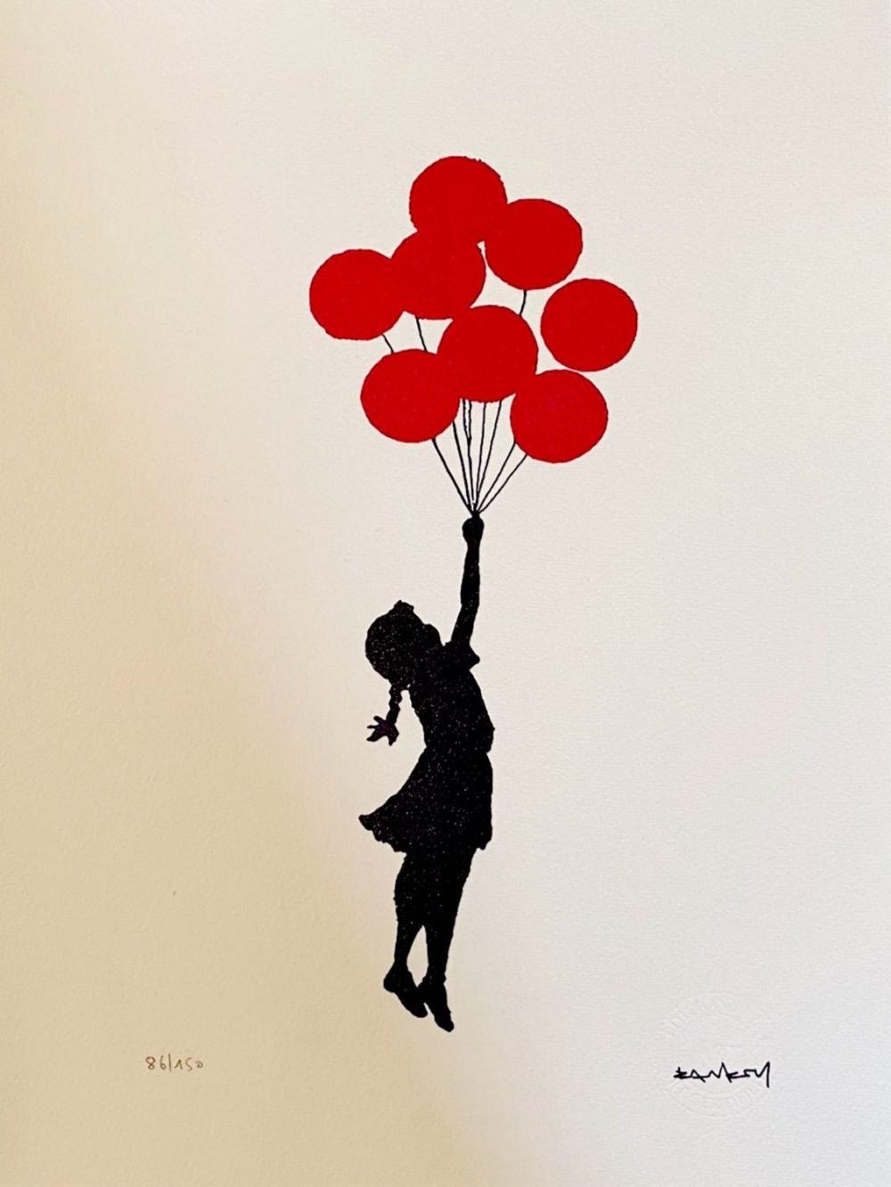 a black silhouette of a girl is holding onto red balloons as she floats upwards.  the background is off white. the artwork is a stencil and spray paint technique and is in the style of banksy.
