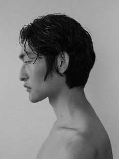 this is a black and white portrait of a young asian man with short hair. the man is shown in profile, with his face turned to the left. the lighting is soft and even, creating a smooth and natural look.