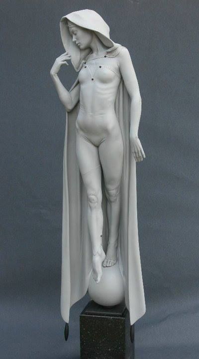 the image showcases a meticulously crafted white sculpture of a woman. she stands gracefully on a small sphere, her body draped in flowing fabric that forms a hood over her head. her pose exudes a sense of balance and serenity. the sculpture is positioned against a neutral gray background, and soft lighting accentuates its contours and the delicate drape of the fabric.