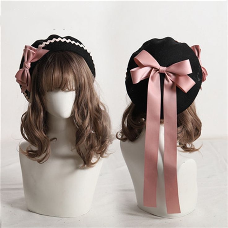 two manikins wearing hats are shown. the hats are black with a pink bow. the hats have a white scalloped edge. the manikins are wearing wigs. the wigs are brown. the background is white.