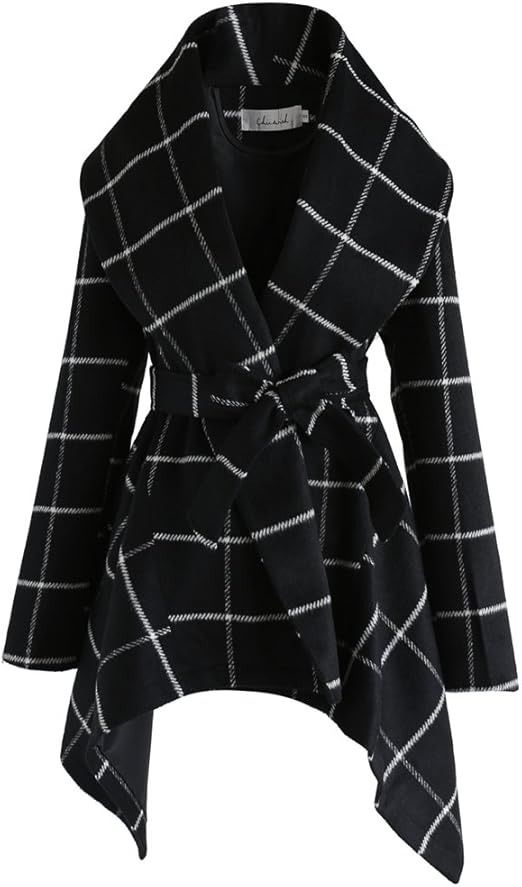 a black and white plaid coat with an oversized collar, a belted waist, and an asymmetrical hem. the coat is longsleeved and has a casual style.
