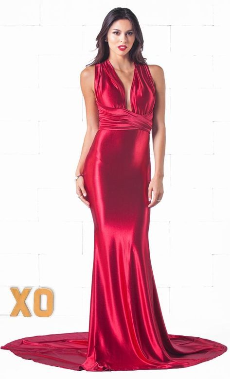 a fulllength studio shot of a woman in a stunning red satin maxi dress. the dress features a halter neckline, a crisscross bodice, and a figurehugging silhouette. the model is posing against a white background with a slight train, exhibiting the dress' elegance and sophistication. the lighting enhances the richness of the red satin fabric.