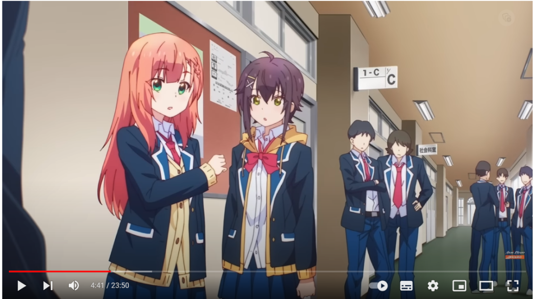 the image shows a screenshot of an anime featuring two school girls in sailor uniforms, one with long coral pink hair and the other with brown hair. they appear to be engaged in a conversation in a brightly lit school hallway, with other students in the background.  the dominant colors are white, blue, and pink, reflecting the typical school uniform colors and the vibrant hair color of the characters.