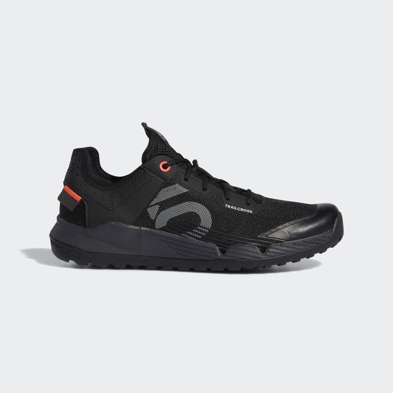 a black five ten trailcross shoe with orange accents is shown against a white background.