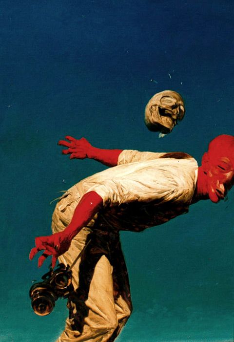 a surreal painting depicting a man with a red head throwing a skull in the air. the background is blue. the painting is surreal and strange, creating a sense of fantasy and dreamlike quality. the man's red head and the skull create a sense of unease and intrigue. the painting is very well done, with the details and the colors being very impressive. it is a very compelling and intriguing image.