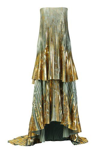 a strapless dress with metallic gold and silver coloring is shown. the dress is pleated and features a tiered design with a highlow hem.