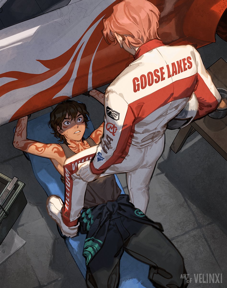 an animestyle illustration depicts a man lying on a padded surface, seemingly working under a vehicle, while another person assists. the man underneath has brown hair, an openmouthed expression of worry or surprise, and visible tattoos on his arms. the assistant, possibly a woman, is wearing a white and red uniform with the words "goose lakes" on the back. she has pink hair and is holding onto the man's pants or legs, appearing to help him into them. the scene suggests a garage or workshop setting, with parts of the vehicle visible above them.