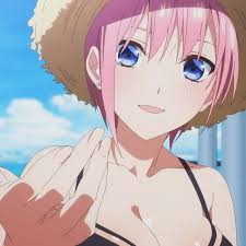 an animestyle image of ichika nakano from "the quintessential quintuplets" wearing a straw hat and bikini. she has pink hair, blue eyes, and is gesturing with her hand in front of a beach background.