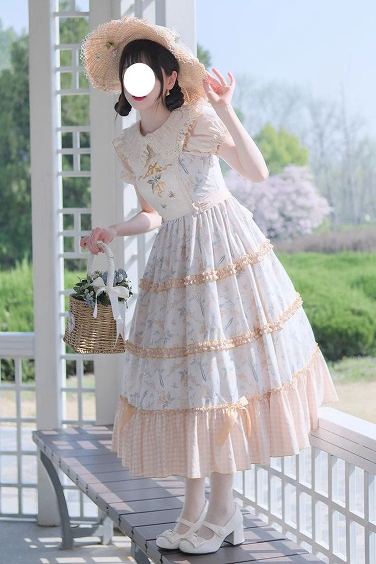 a young woman in a delicate, floral lolita dress stands on a gazebo. she's wearing a widebrimmed straw hat and carrying a picnic basket with blue flowers. the dress is a light, pastel color with lace and ribbon details, and she is wearing white shoes with ankle straps. the gazebo is white and surrounded by greenery, and the overall feeling of the image is light, airy, and romantic.