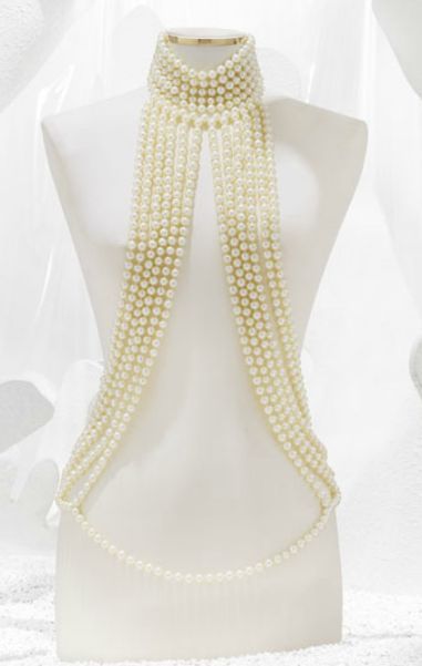 a white mannequin is displayed wearing a pearl body necklace with many strands. the background is white.