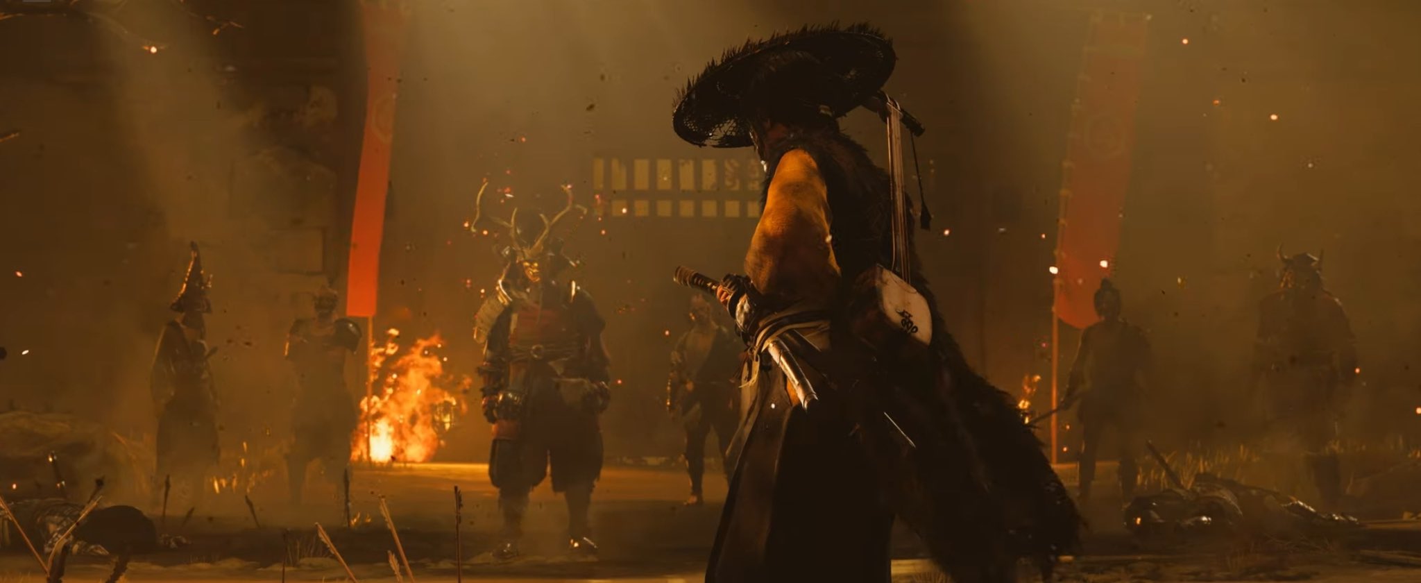 a samurai in a black and yellow outfit with a large hat stands in the center of a firelit battle. he is holding a sword, and there are other samurai around him, some dead. the scene is set in a dark and mysterious forest with smoke and fire swirling around the combatants. the image is a screenshot from the video game ghost of tsushima, which is set in 13th century japan. the samurai in the center of the image is jin sakai, the protagonist of the game. he is fighting against the mongol invaders who have invaded the island of tsushima.