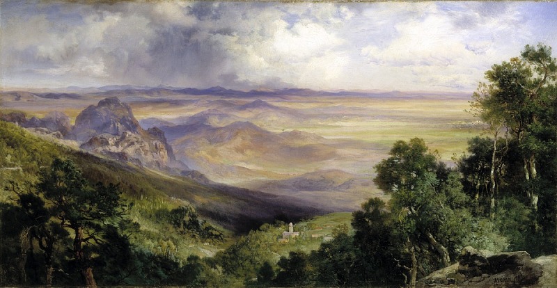 the painting depicts a vast, panoramic landscape dominated by mountains and valleys. the foreground features lush green trees and rocky outcrops on either side, framing the view. a valley stretches out towards the center, where a small town with a church spire is nestled among the foliage. beyond the valley, a series of mountains fade into the distance, painted with soft, muted colors that suggest atmospheric perspective. the sky above is filled with dramatic clouds, with some areas indicating rain or storm. the overall impression is one of grandeur, tranquility, and the beauty of nature.