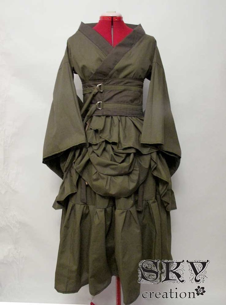a green and brown steampunkstyle kimono dress with a black bodice, ruffled skirt, and multiple buckled belts.