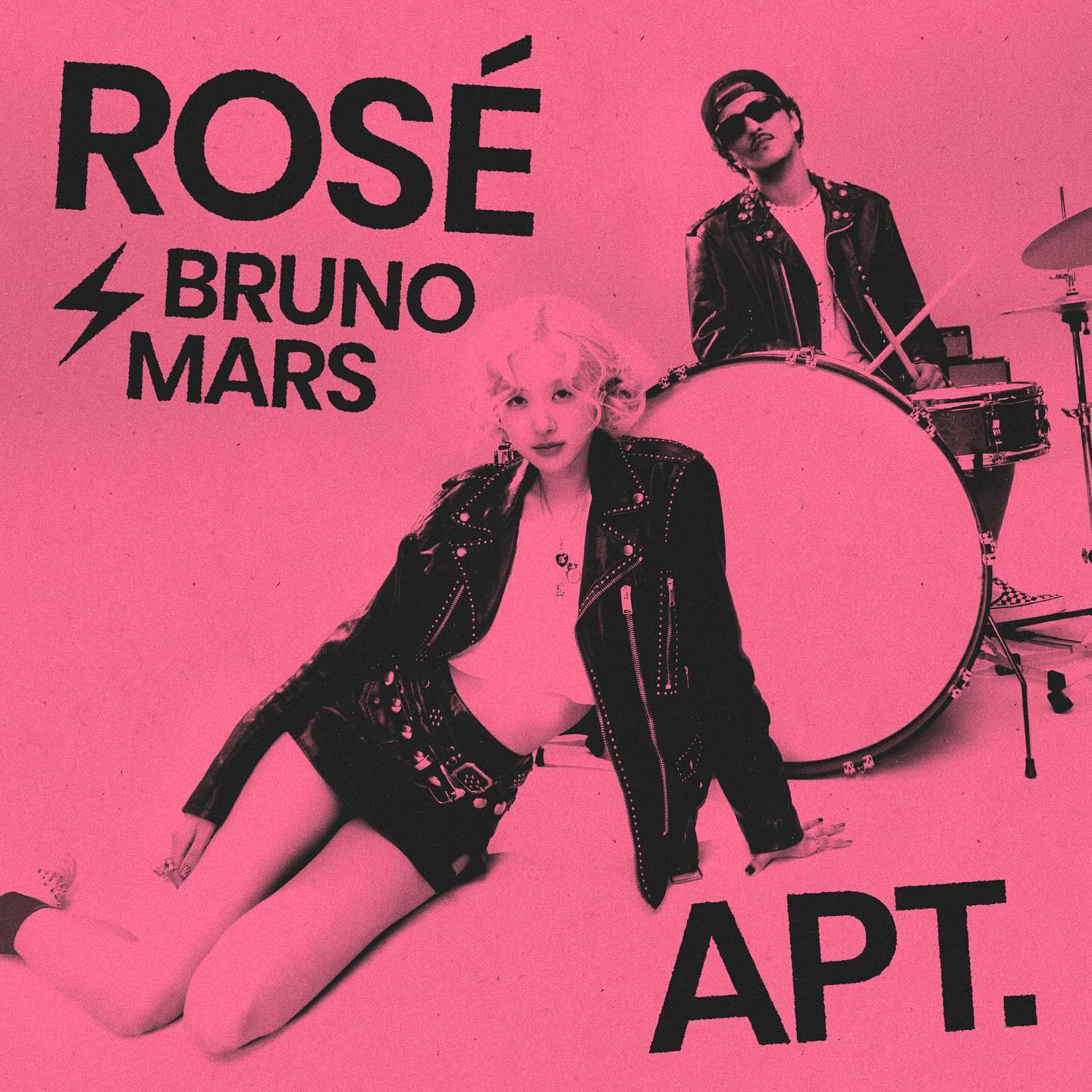 the image is a promotional artwork for a collaboration single between rosé (of the south korean girl group blackpink) and bruno mars, titled "apt."  the artwork features rosé and a male drummer, both styled in a retroinspired, edgy fashion.  rosé is lying on the floor, wearing a leather jacket and short shorts, while the male drummer sits behind a drum kit. the background is a solid pink color, and the title text is prominently displayed. the overall style is sleek and modern with a nostalgic touch.
