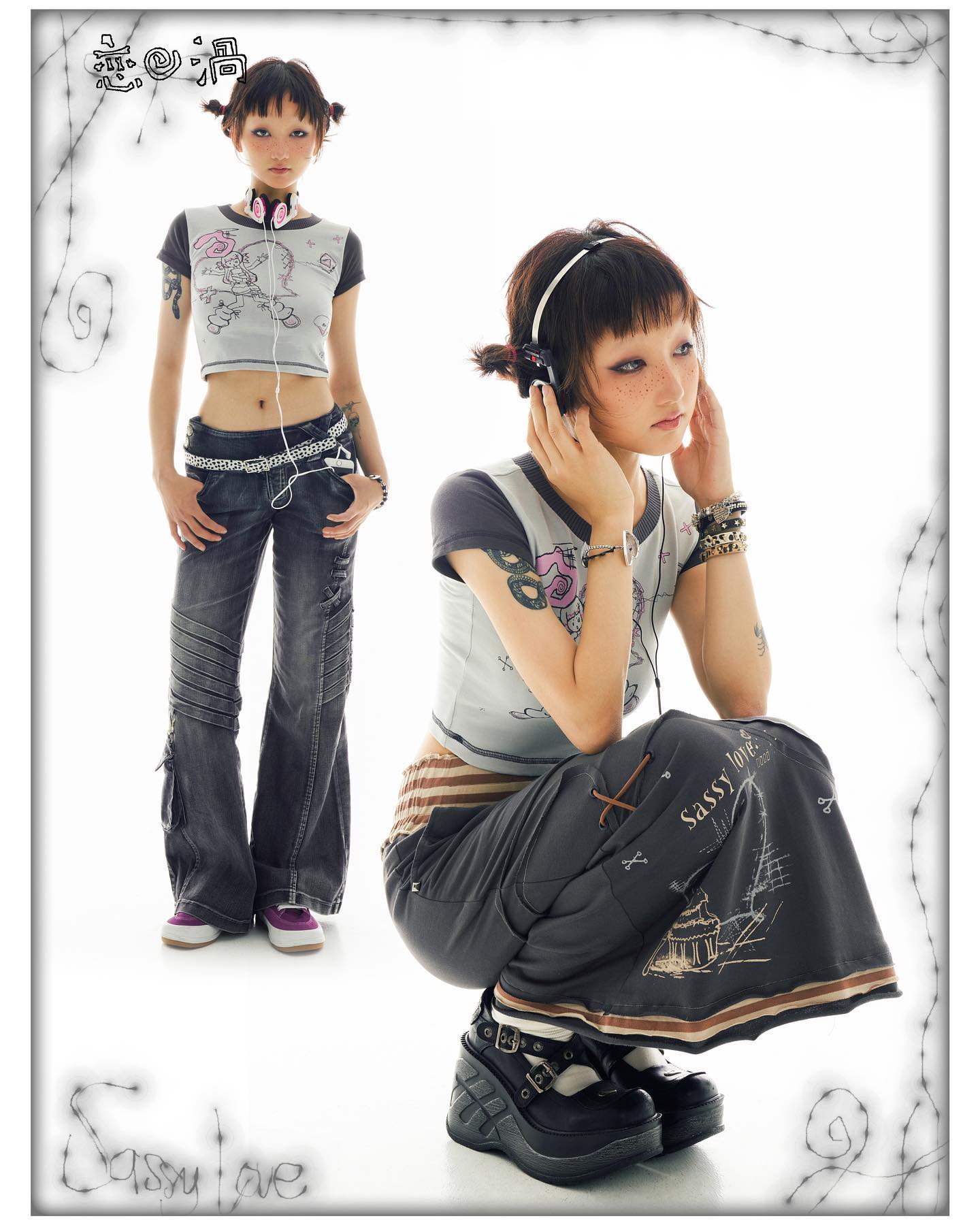 the image features two young women showcasing different styles of japanese fashion. the woman on the left is wearing a cropped graphic tee, belted jeans, and purple sneakers, exuding a punkinspired vibe. the woman on the right is crouched down, wearing a gray graphic top and a darkgray printed long skirt paired with platform boots, demonstrating a more lolitainfluenced style. both are wearing headphones and have similar hairstyles. the backdrop is white, and the overall style is heavily influenced by harajuku fashion, characterized by its eclectic mix of punk and cute elements.  a logo for "sassy love" is visible in the image.