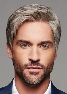 this is a headshot of a male model with gray hair styled in a modern haircut. he has a short, wellgroomed beard and is wearing a blue suit jacket and white shirt. the image is welllit with studio lighting and taken from an eyelevel perspective, creating a professional and approachable feel.
