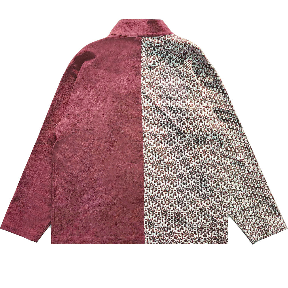the image shows a longsleeved jacket. the jacket is split in half, with one side maroon and the other side covered in a pattern. the jacket has a collar.