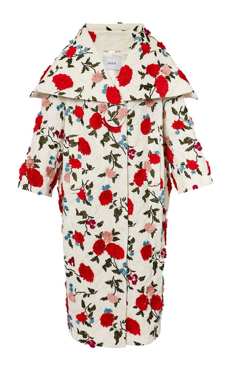 a white coat with red and pink embroidered flowers and green leaves. it has a large collar and a single button closure.