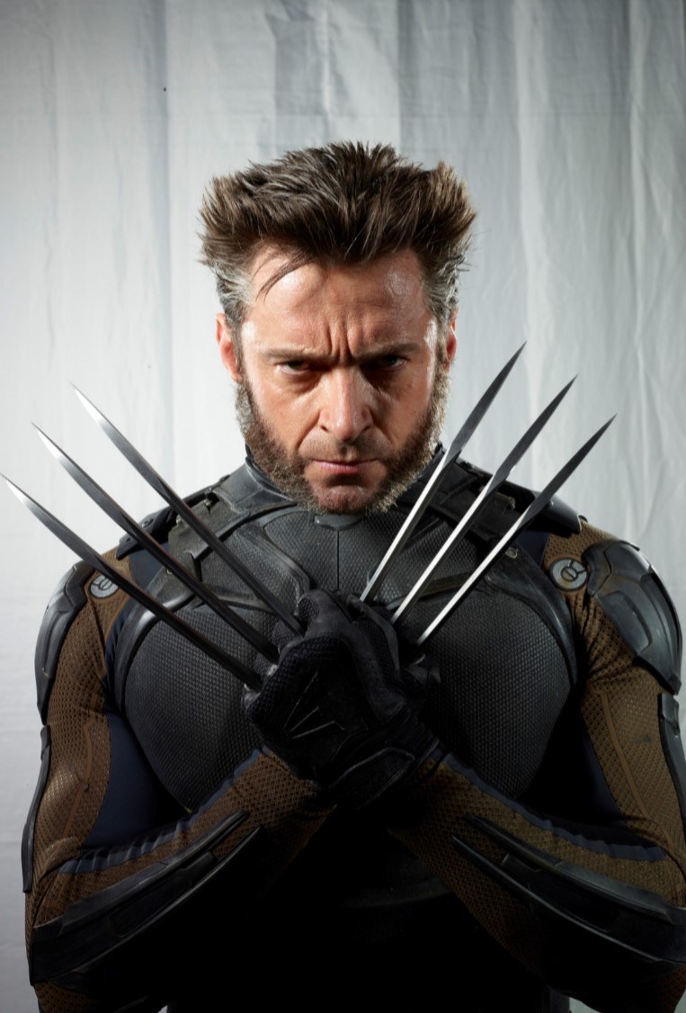 this is a portrait of hugh jackman as wolverine, a superhero from marvel comics. he is wearing a dark costume with brown accents and black gloves, and his signature silver claws are extended from his knuckles. he has a menacing expression on his face and his facial hair is styled in a pointed manner. the background is a wrinkled white surface. he appears to be muscular and strong, befitting the character he is portraying.