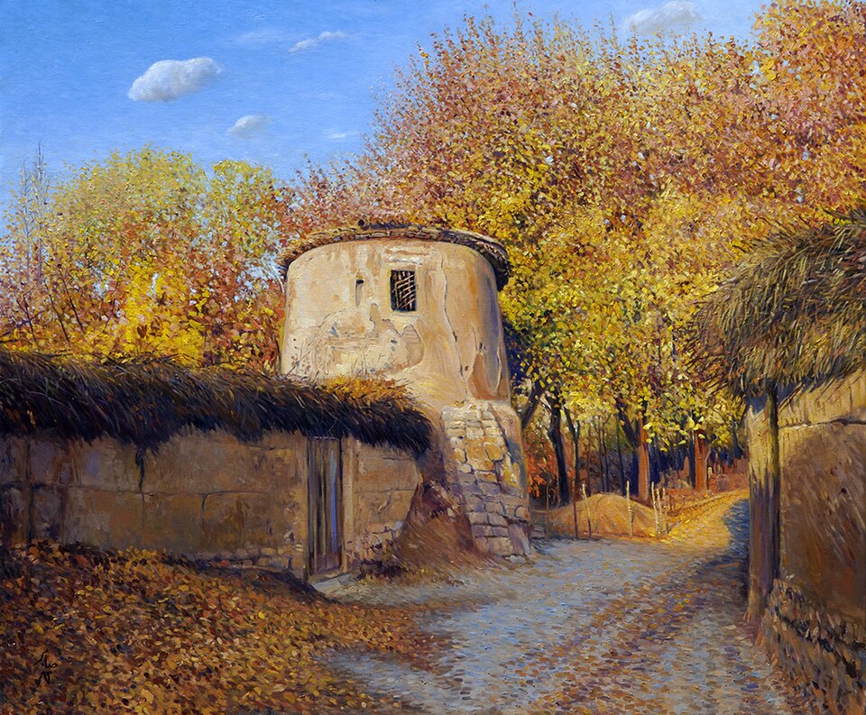 this is a painting depicting a rural autumn landscape. the scene features an old, weathered building with a tower on the left side of the road, adorned with a thatched roof on the adjacent wall. the road is paved with cobblestones and is covered in fallen autumn leaves. trees with golden and orange foliage line the road, creating a vibrant autumn atmosphere. the sky is blue with a few scattered clouds. the painting style is reminiscent of traditional landscape art, capturing the essence of a quaint village scene in the fall.