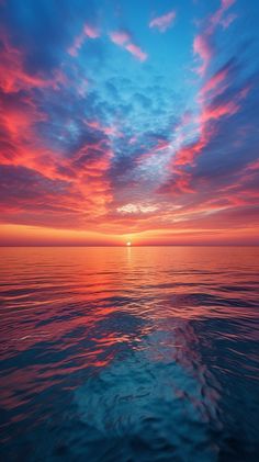 the image is a breathtaking vista of a sunset over a serene body of water, likely the ocean or a large lake. the sky blazes with vibrant hues of orange, red, and pink, casting a warm glow over the rippling waves below. the sun, a fiery orb, hovers just above the horizon, its rays reflected in the tranquil water. the composition evokes a sense of peace and tranquility, inviting the viewer to immerse themselves in the beauty of nature.