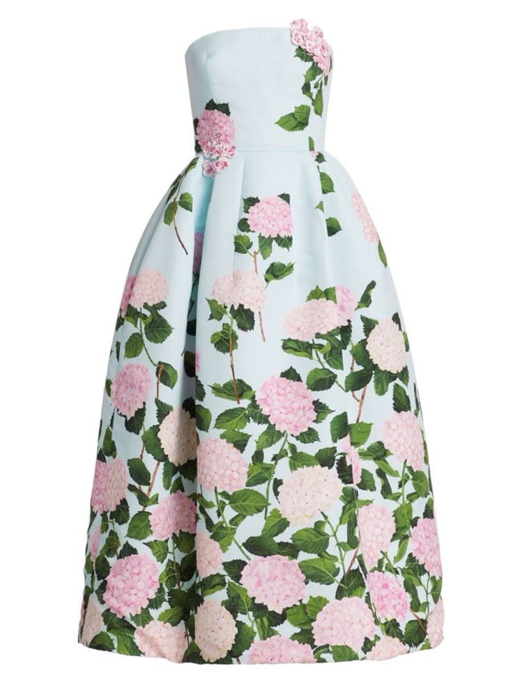 the image shows a light blue strapless dress with a large, full skirt that flares out from the fitted bodice. the dress is adorned with a floral print featuring pink and white hydrangea flowers and green leaves. there are also threedimensional pink flower embellishments on the top of the bodice. the skirt appears to be pleated at the waist, adding to its voluminous shape. the dress is positioned against a white background.