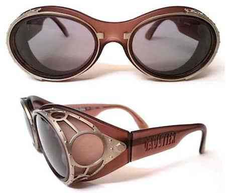 the image shows two pairs of vintagestyle sunglasses. the sunglasses feature a brown frame, tinted lenses, and intricate metal detailing on the sides, giving them a steampunk aesthetic. the design includes side shields, adding to the retro look. the brand "vavoutier" is visible on the side of one pair.