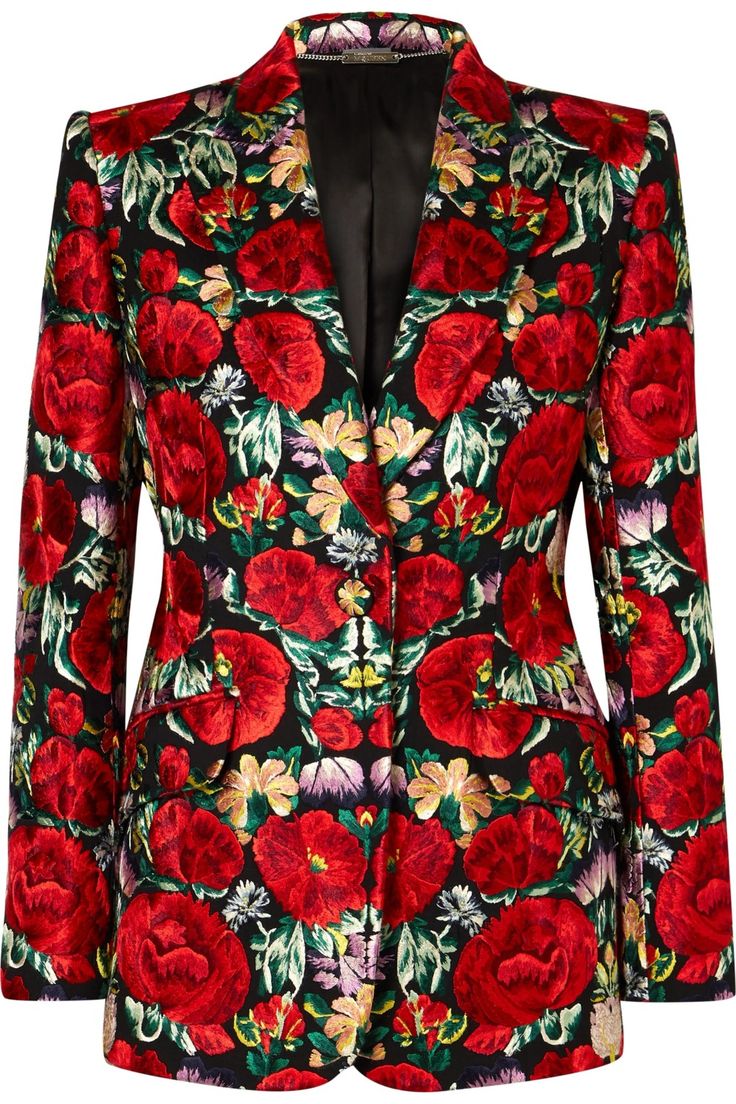 the image showcases a women's blazer with a bold floral pattern. the blazer features vibrant red flowers against a black background, creating a striking contrast. it has a tailored fit with a lapel collar, suggesting a formal or sophisticated style. the overall design is elaborate and eyecatching, likely intended for a fashionable statement.