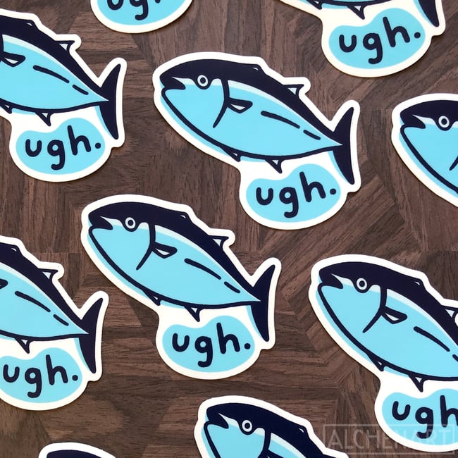 the image shows multiple stickers arranged on a dark brown wooden surface. each sticker features a cartoon drawing of a light blue tuna fish with dark blue fins and outlines.  underneath each tuna is a speech bubble containing the word "ugh." in a simple, handwrittenstyle font. the stickers are scattered across the surface, partially overlapping, showcasing their design from various angles.  the overall aesthetic is clean, simple, and slightly humorous.