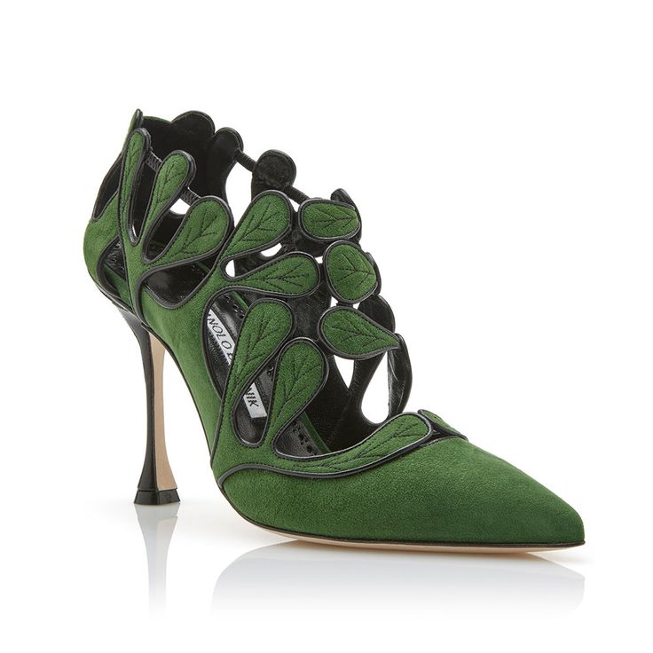 the image showcases a single elegant women's high heel shoe from nicholas kirkwood. the shoe is a vibrant green suede with intricate cutout detailing in the shape of leaves.  black leather accents are visible within the cutouts. the shoe has a pointed toe and a delicate stiletto heel. the shoe is presented against a white background, with its reflection subtly visible beneath it. the brand name is partially visible on the insole.