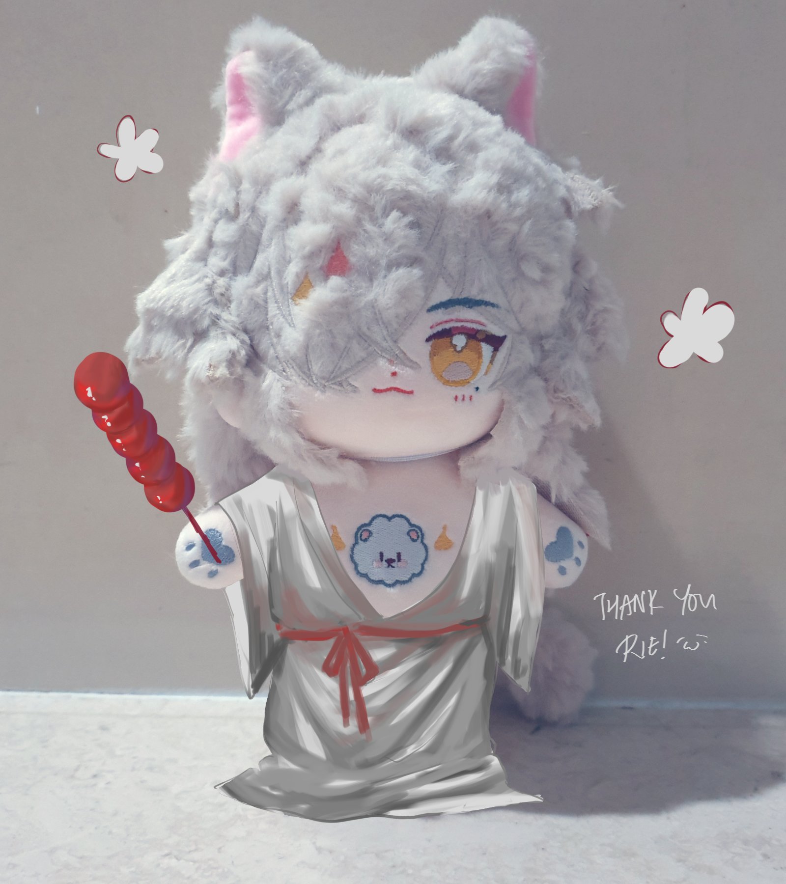 a white plush toy with cat ears and a grey dress is holding a red candy stick in one hand. the toy has its eyes closed and a red ribbon tied around its waist. the toy is against a pastel background and has a thank you note that says "thank you rie!" written on it.
