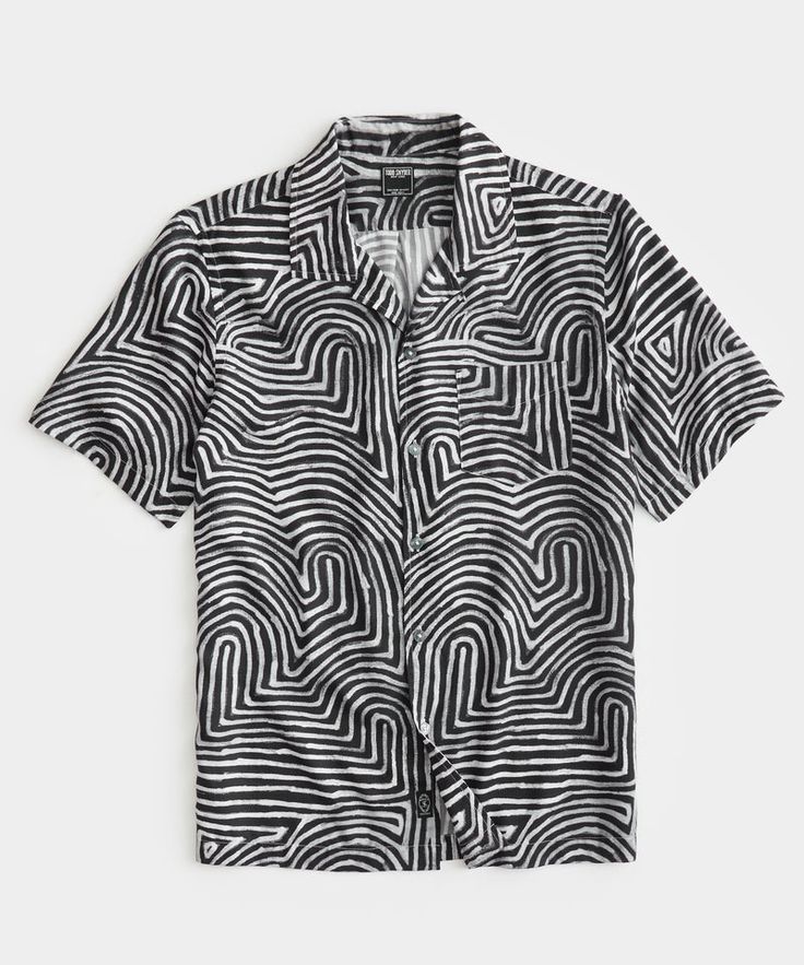 a black and white shortsleeved buttondown shirt with an abstract pattern.