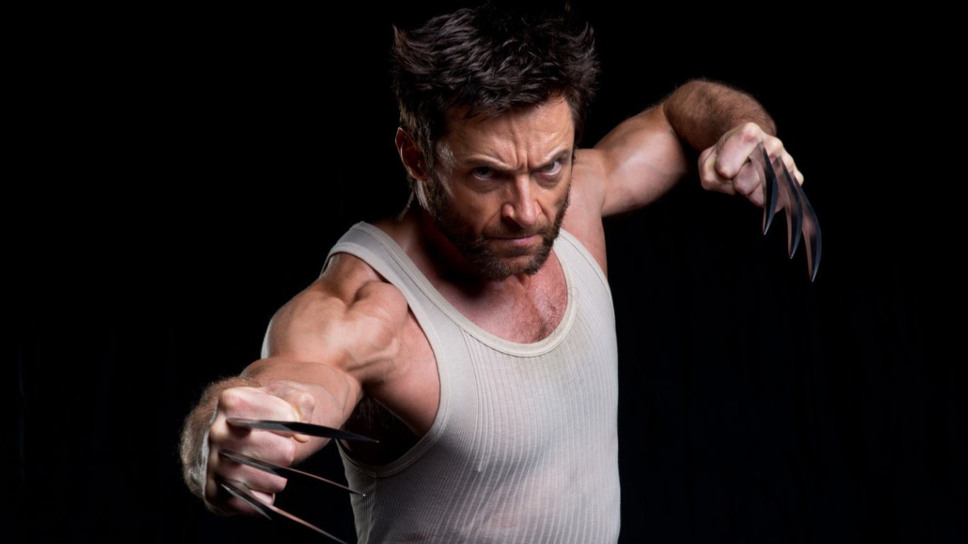 image of hugh jackman as wolverine, posed with claws extended, wearing a tank top, against a black background.