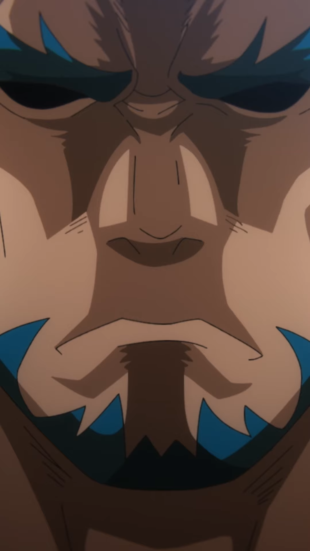 the image shows a closeup of a man's face. the man has a serious expression on his face and his eyes are closed. he has blue tribal tattoos on his face. the image is in color and the man's skin is brown.