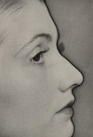 a black and white closeup profile portrait of a young audrey hepburn.  the image emphasizes her delicate features, focusing primarily on her eye, nose, and mouth.  the lighting and shading create a dramatic effect, highlighting the contours of her face. the background is blurred and out of focus, drawing all attention to the subject.  the overall style is classic and elegant, reminiscent of classic hollywood portrait photography.