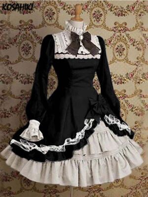 a black and white gothic lolita dress is shown on a mannequin. the dress has a high collar, long sleeves, and a full skirt with layers of lace. there is a bow at the neck and another on the skirt. the dress is in a victorian style.