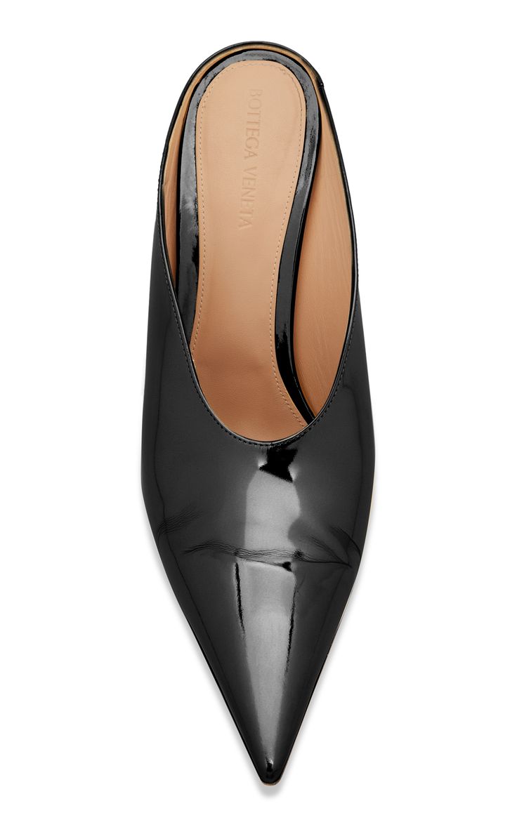 a topdown view of a pair of bottega veneta black patent leather pointedtoe mules. the shoes are elegant and stylish with a glossy finish. the brand's logo is subtly visible inside the shoe. the shoes are presented on a white background.