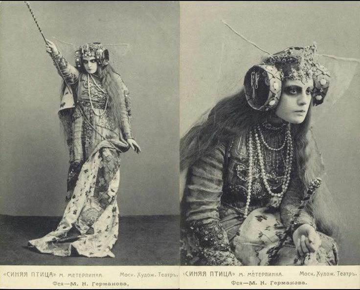 two black and white photographs are joined together, forming a single image. the subject of both photos is a woman dressed in an elaborate, historicallooking costume and makeup, presumably an actress in a theatrical production. the lefthand photo shows the woman in a fullbody shot, standing and holding a wand or scepter aloft in her right hand. she is wearing a decorative headdress, a patterned gown with a long, flowing cape, and what appears to be multiple strands of pearl necklaces. the righthand photo is a closeup portrait of the same woman, seated. the details of her headdress, makeup, and the intricate design of her costume are more clearly visible. the text below each photograph indicates that the production is "the blue bird" by maurice maeterlinck, performed at the moscow art theatre, and the actress is m. n. germanova, playing the role of a fairy.