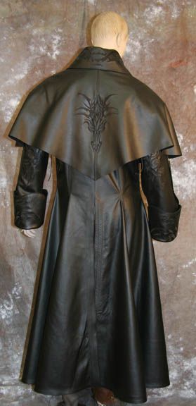 the image features a fulllength view of a black leather coat with a cape, worn on a mannequin. the coat has a gothic fashion style with an embroidered dragon design on the back of the cape. the cape drapes over the shoulders and upper back of the coat, adding a dramatic element to the design. the coat is long, reaching down to the ankles, and it appears to be made of highquality, supple leather. the overall look is stylish and reminiscent of gothic or fantasy fashion. the mannequin's bald head is visible above the coat's collar. the background is a neutral texture, focusing attention on the coat itself.
