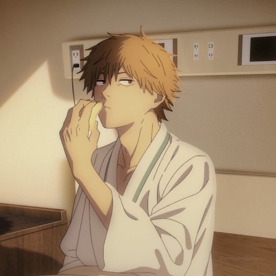 the image shows an anime boy sitting on a hospital bed. he has blonde hair and is wearing a white hospital gown. the boy looks lonely and upset while eating a piece of fruit.  the room is a hospital room with a window, a wall, and a bed.