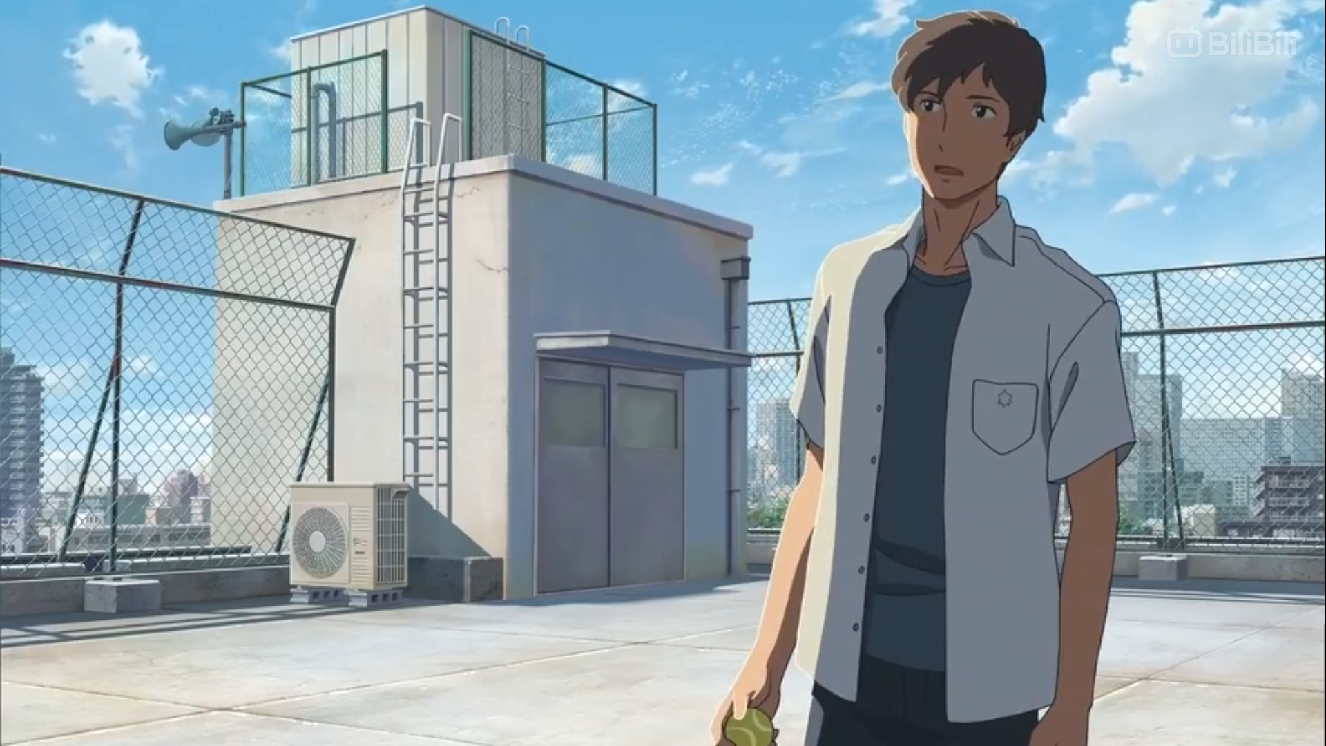 a young man with short brown hair and a melancholic expression stands on a rooftop in the daytime. he's wearing a light blue, shortsleeved, collared shirt and dark pants. he's holding something small and unidentifiable in his right hand. the rooftop is surrounded by a chainlink fence, and various rooftop structures, including a water tower and an air conditioning unit, are visible.  the city stretches out behind him under a bright blue sky with fluffy white clouds.