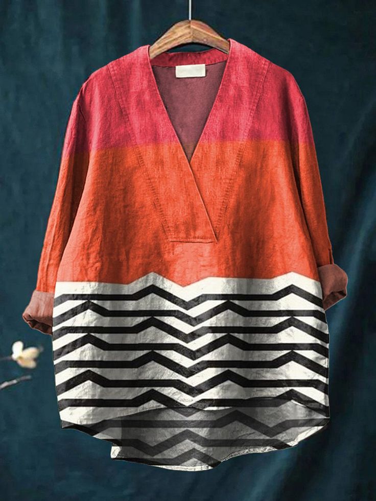 this is a women's long sleeve vneck shirt. it is made of a light, breathable fabric and features a colorful, geometric pattern. the shirt is perfect for casual wear and can be styled with jeans, skirts, or shorts.  the shirt has a relaxed fit and is available in a variety of sizes.  it's perfect for a day out or a night out.