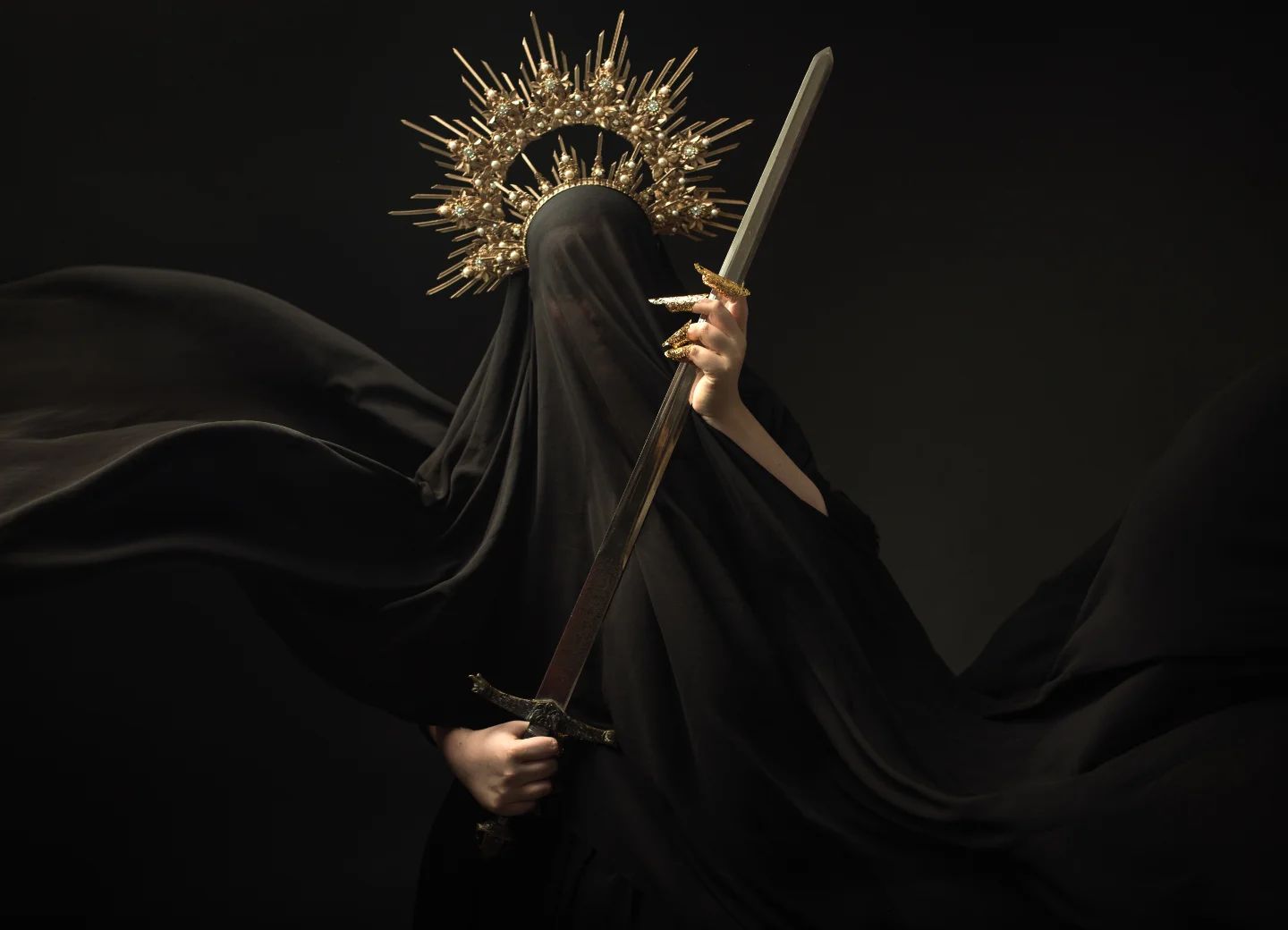 a dramatic, stylized portrait of a woman shrouded in a flowing black robe. she wears a golden crown resembling a halo and holds a sword. her face is concealed, adding to the mysterious and powerful aura of the image. the dark background and dramatic lighting enhance the overall mood and aesthetic. the image evokes themes of fantasy, gothic style, and strong female characters.