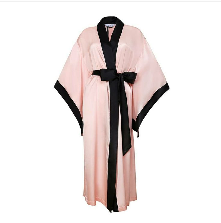 a  pink silk robe with black trim and a sash is shown in the image. it has long sleeves and a  kimono style cut.