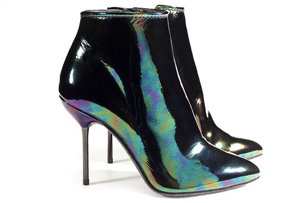 a pair of women's iridescent ankle boots with stiletto heels and pointed toes. the boots are primarily black but have a shimmering, rainbowlike effect due to their iridescent patent leather finish.  one boot is slightly behind the other, showing both the front and side profiles.  the shoes appear to be new and unworn.