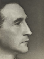 the image is a black and white, closeup profile portrait of a man. the photograph is taken from the side, showing his facial features clearly.  he appears to be middleaged, with a serious or contemplative expression. his features are sharply defined, and the lighting creates strong contrasts, highlighting the texture of his skin. the background is dark and unfocused, drawing attention solely to the subject.  the overall style suggests a classic or artistic approach to portrait photography, possibly from the mid20th century.