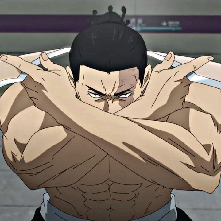 a shirtless and muscular anime character with his arms crossed in an x shape in front of his face. he is standing indoors, possibly in a train station, and there is bright artificial lighting. he has a serious and intimidating expression. his hair is styled in a top knot, and he has scars visible on his face.