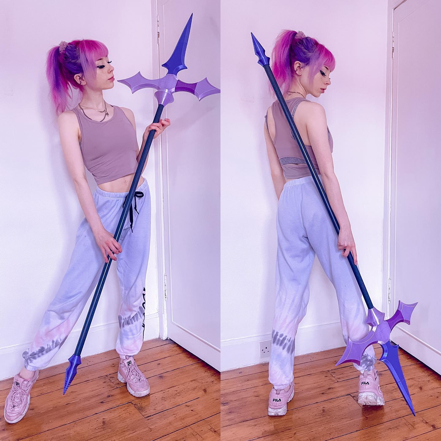 the image shows a young woman cosplaying, posing with a large, purple and black spear. the spear is intricately designed and appears to be a prop, possibly 3dprinted. the woman has bright pink hair, is wearing a light purple tiedye sweatpants and a mauvecolored tank top, and fila sneakers. the background is a light pink wall. the images are two separate views of the same pose, one from the front and the other from the back, showcasing the prop in full detail. the overall style is light and ethereal.
